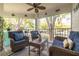 Relaxing screened porch with wicker furniture and ceiling fan at 3578 Indigo Pond Dr, Palm Harbor, FL 34685