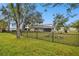 Backyard view of house with screened porch and fence at 3915 W Pearl Ave, Tampa, FL 33611