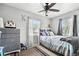 Well-lit bedroom with a queen bed and dresser at 3915 W Pearl Ave, Tampa, FL 33611