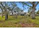 House exterior with stone fire pit and trees at 3915 W Pearl Ave, Tampa, FL 33611