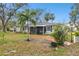 Tan house with screened porch and brick walkway at 3915 W Pearl Ave, Tampa, FL 33611