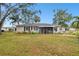 Backyard view of the house and screened porch at 3915 W Pearl Ave, Tampa, FL 33611