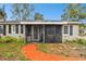 Home features a screened porch and brick walkway at 3915 W Pearl Ave, Tampa, FL 33611