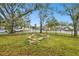 Landscaped front yard with stone accents and a black metal fence at 3915 W Pearl Ave, Tampa, FL 33611