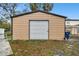 Tan metal garage with a roll-up door at 3915 W Pearl Ave, Tampa, FL 33611