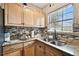 Kitchen with granite countertops and wooden cabinets at 3915 W Pearl Ave, Tampa, FL 33611