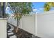 Landscaped backyard with a stone path and a white vinyl fence at 3925 1St Ne St, St Petersburg, FL 33703