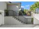 Stairs leading to a patio, featuring a metal railing and potted plants at 3925 1St Ne St, St Petersburg, FL 33703