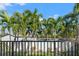 View of a backyard with lush palm trees and a fence at 3925 1St Ne St, St Petersburg, FL 33703