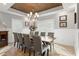 Elegant dining room with a wood table, gray chairs, and a wood-beamed ceiling at 3925 1St Ne St, St Petersburg, FL 33703