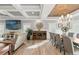 Bright dining room features a large wooden table, gray chairs, and a stunning chandelier at 3925 1St Ne St, St Petersburg, FL 33703