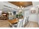 Sunlit dining room features a long wooden table and comfortable gray chairs at 3925 1St Ne St, St Petersburg, FL 33703