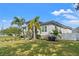 Side view of a charming single-Gathering home with lush landscaping and a fenced yard at 3925 1St Ne St, St Petersburg, FL 33703