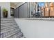 Steps leading to the front entrance with a modern railing and potted plants at 3925 1St Ne St, St Petersburg, FL 33703