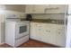 Galley kitchen with white cabinets and appliances at 4034 39Th N Ave, St Petersburg, FL 33714