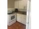 Simple kitchen with white cabinets and appliances at 4034 39Th N Ave, St Petersburg, FL 33714