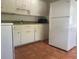 Galley kitchen with white cabinets and appliances at 4034 39Th N Ave, St Petersburg, FL 33714