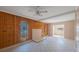 Living room with wood paneling, tile floors, and multiple windows at 4135 4Th N Ave, St Petersburg, FL 33713