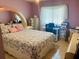 Bedroom with floral bedding and built-in desk at 4209 Amber Ridge Ln, Valrico, FL 33594