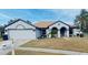 One-story home with a two-car garage and well-manicured lawn at 4209 Amber Ridge Ln, Valrico, FL 33594