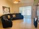 Living room with sectional sofa, large window and sliding glass doors at 4209 Amber Ridge Ln, Valrico, FL 33594