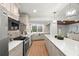 Modern kitchen with white cabinets, stone backsplash, and island at 4320 Middle Lake Dr, Tampa, FL 33624