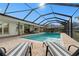 Inviting screened pool area with lounge chairs and patio at 4320 Middle Lake Dr, Tampa, FL 33624