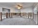 Large living area with exposed framing and damaged walls, ready for renovation at 4730 Shore Acres Ne Blvd, St Petersburg, FL 33703