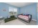 Cozy bedroom with daybed and blue walls at 5130 Adega Way, Bradenton, FL 34211