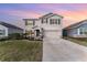 Two-story house with gray shutters, stone accents, and a two-car garage at 5130 Adega Way, Bradenton, FL 34211