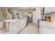 Open kitchen with white cabinets and marble countertops at 5130 Adega Way, Bradenton, FL 34211