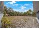 Large backyard with mature trees and a gravel pathway at 5290 38Th S Way, St Petersburg, FL 33711