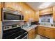 Bright kitchen with wood cabinets, stainless steel appliances, and ample counter space at 5290 38Th S Way, St Petersburg, FL 33711