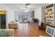 Living room with brick fireplace, hardwood floors, and built in shelving at 5290 38Th S Way, St Petersburg, FL 33711