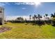 Spacious backyard with grassy lawn and palm trees at 5453 Del Coronado Dr, Apollo Beach, FL 33572