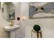 Stylish bathroom with pedestal sink, framed art and gold accents at 5453 Del Coronado Dr, Apollo Beach, FL 33572