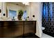 Modern bathroom with double vanity, stylish decor, and a geometric shower curtain at 5453 Del Coronado Dr, Apollo Beach, FL 33572