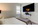 Bedroom with a queen bed, wall-mounted TV, and window with blinds at 5453 Del Coronado Dr, Apollo Beach, FL 33572