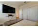 Bright bedroom with large TV, double doors, and a comfortable bed at 5453 Del Coronado Dr, Apollo Beach, FL 33572