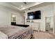 Main bedroom with large TV, dresser, and ensuite bathroom access at 5453 Del Coronado Dr, Apollo Beach, FL 33572
