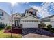 Two-story house with brick driveway and red shutters at 5453 Del Coronado Dr, Apollo Beach, FL 33572