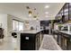Modern kitchen with black cabinets and marble countertops at 5453 Del Coronado Dr, Apollo Beach, FL 33572