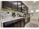 Modern kitchen with marble countertops, black cabinets and gold accents at 5453 Del Coronado Dr, Apollo Beach, FL 33572