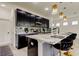 Modern kitchen with marble countertops, black cabinets, and gold accents at 5453 Del Coronado Dr, Apollo Beach, FL 33572
