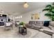 Open living room with sectional sofa, stylish decor and view into kitchen at 5453 Del Coronado Dr, Apollo Beach, FL 33572