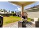 Spacious patio with outdoor seating, a grill, and a view of the green backyard at 5453 Del Coronado Dr, Apollo Beach, FL 33572