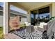 Relaxing covered patio with wicker chairs and modern rug at 5453 Del Coronado Dr, Apollo Beach, FL 33572