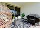 Cozy patio with wicker furniture, grill, and geometric patterned rug at 5453 Del Coronado Dr, Apollo Beach, FL 33572
