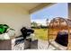 Relaxing patio with wicker chairs, a grill, and a view of the backyard at 5453 Del Coronado Dr, Apollo Beach, FL 33572