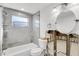 Partially renovated bathroom featuring new vanity with framed round mirror, a new toilet, and a tiled shower and tub at 5600 Bayou Grande Ne Blvd, St Petersburg, FL 33703